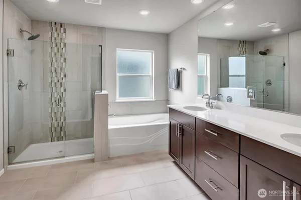 a spacious bathroom with a shower sink and mirror