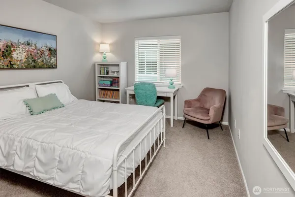 a bedroom with a bed and a lounge chair