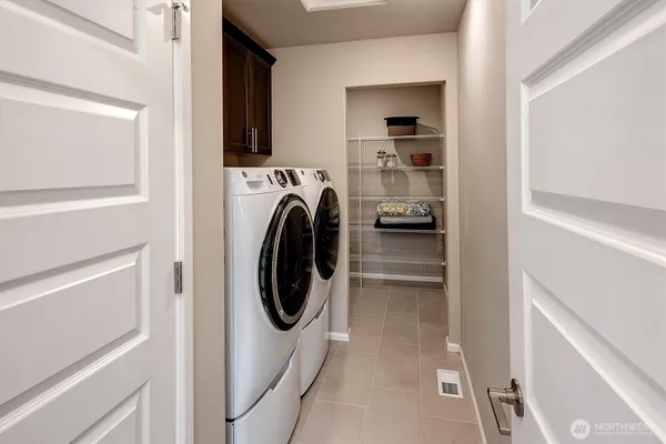 a utility room with washing machine and a view of bedroom