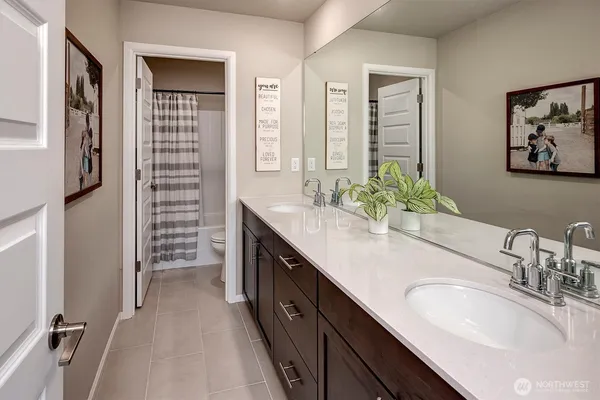 a bathroom with a double vanity sink a mirror and a shower
