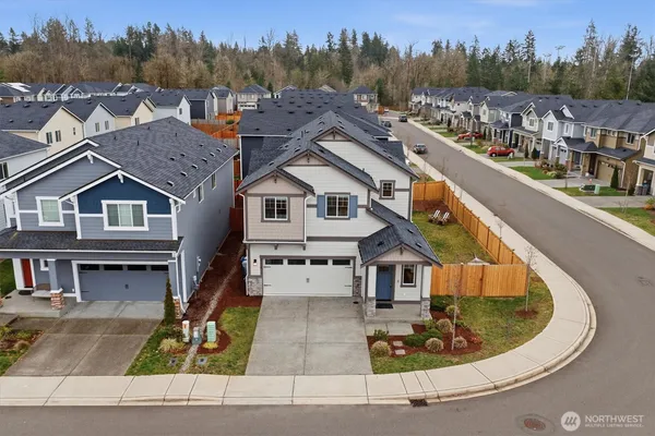 an aerial view of a house with a swimming pool and lake view