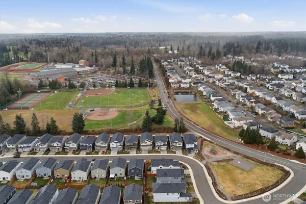 an aerial view of a house with a garden and lake view