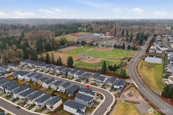 an aerial view of a swimming pool with outdoor seating