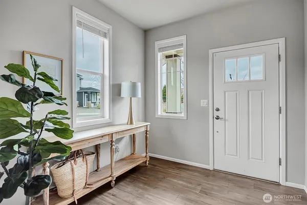 a view of an entryway with wooden floor
