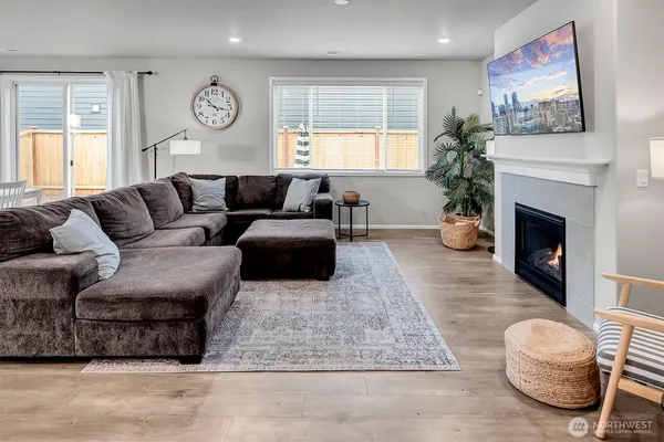 a living room with furniture a fireplace and a flat screen tv