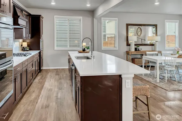 a kitchen with a stove a sink and a refrigerator
