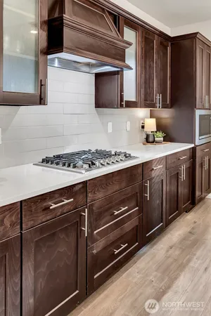 a kitchen with stainless steel appliances kitchen island granite countertop a stove and a microwave