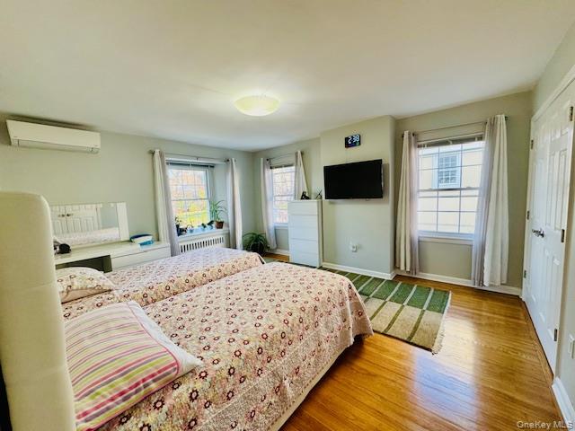 186-22 Avon Road Queens, NY 11432 - Photo 15 of 23 a bedroom with a bed and a flat tv screen on dresser