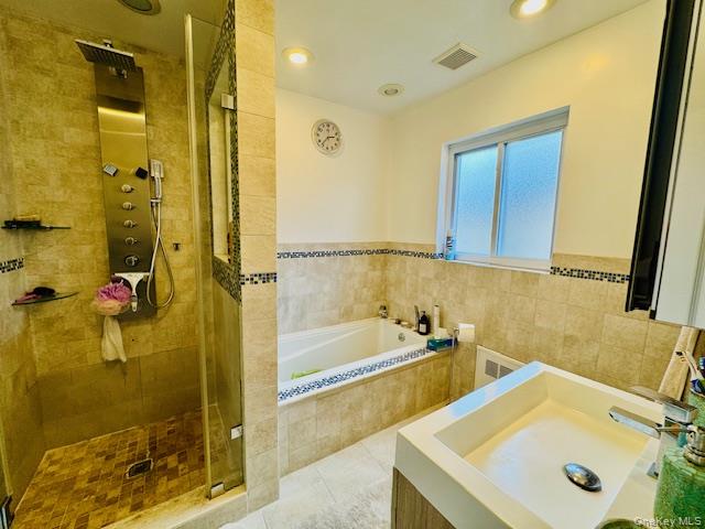 186-22 Avon Road Queens, NY 11432 - Photo 19 of 23 a bathroom with a tub sink and mirror