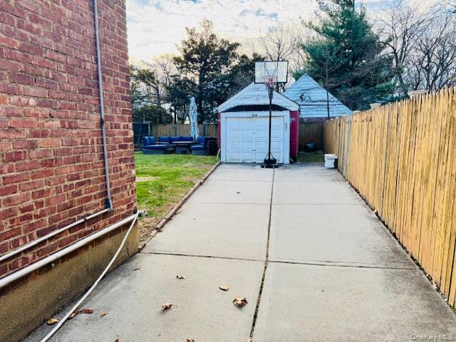 186-22 Avon Road Queens, NY 11432 - Photo 22 of 23 a front view of a house with a yard