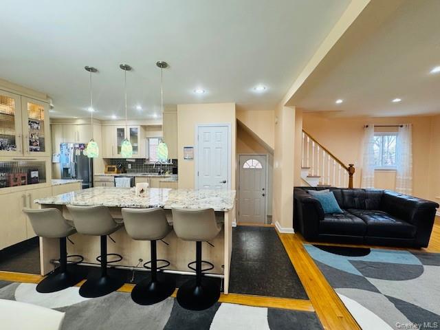 186-22 Avon Road Queens, NY 11432 - Photo 5 of 23 a living room with a couch and a table with wooden floor