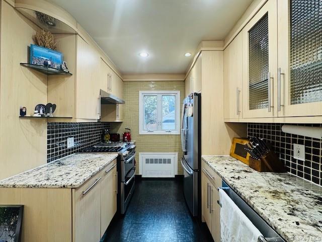 186-22 Avon Road Queens, NY 11432 - Photo 10 of 23 a kitchen with a stove and a kitchen