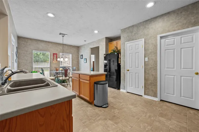a dining room with furniture a chandelier and window