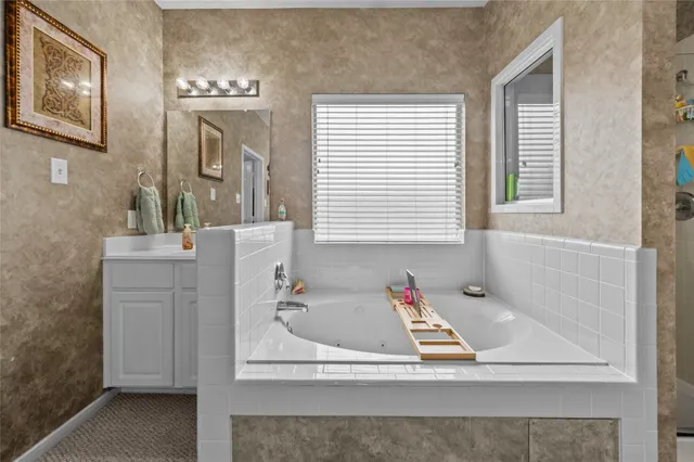 a spacious bedroom with a bed and a chandelier