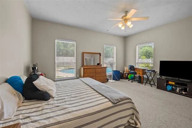 a bedroom with a bed and a book shelf