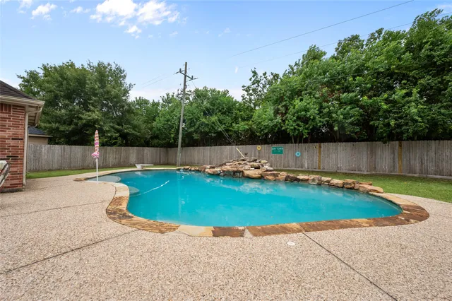 a view of a patio with table and chairs potted plants and a large tree