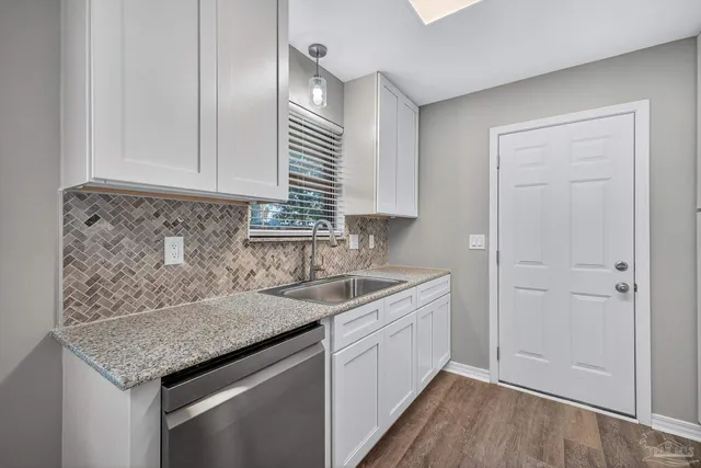a kitchen with a sink and cabinets