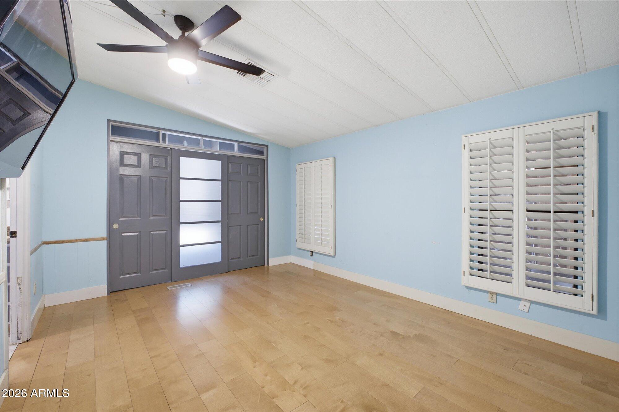 205 South Higley Road, Unit 183 Mesa, AZ 85206 - Photo 12 of 30 a view of an empty room with a window and a kitchen