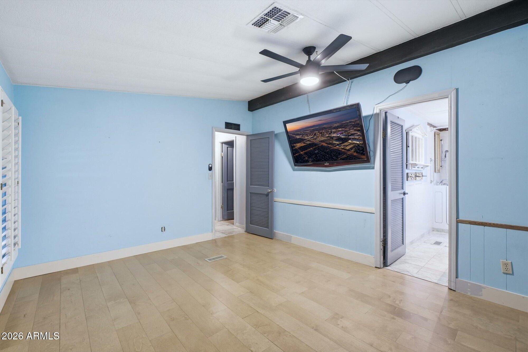 205 South Higley Road, Unit 183 Mesa, AZ 85206 - Photo 13 of 30 an empty room with windows and fan