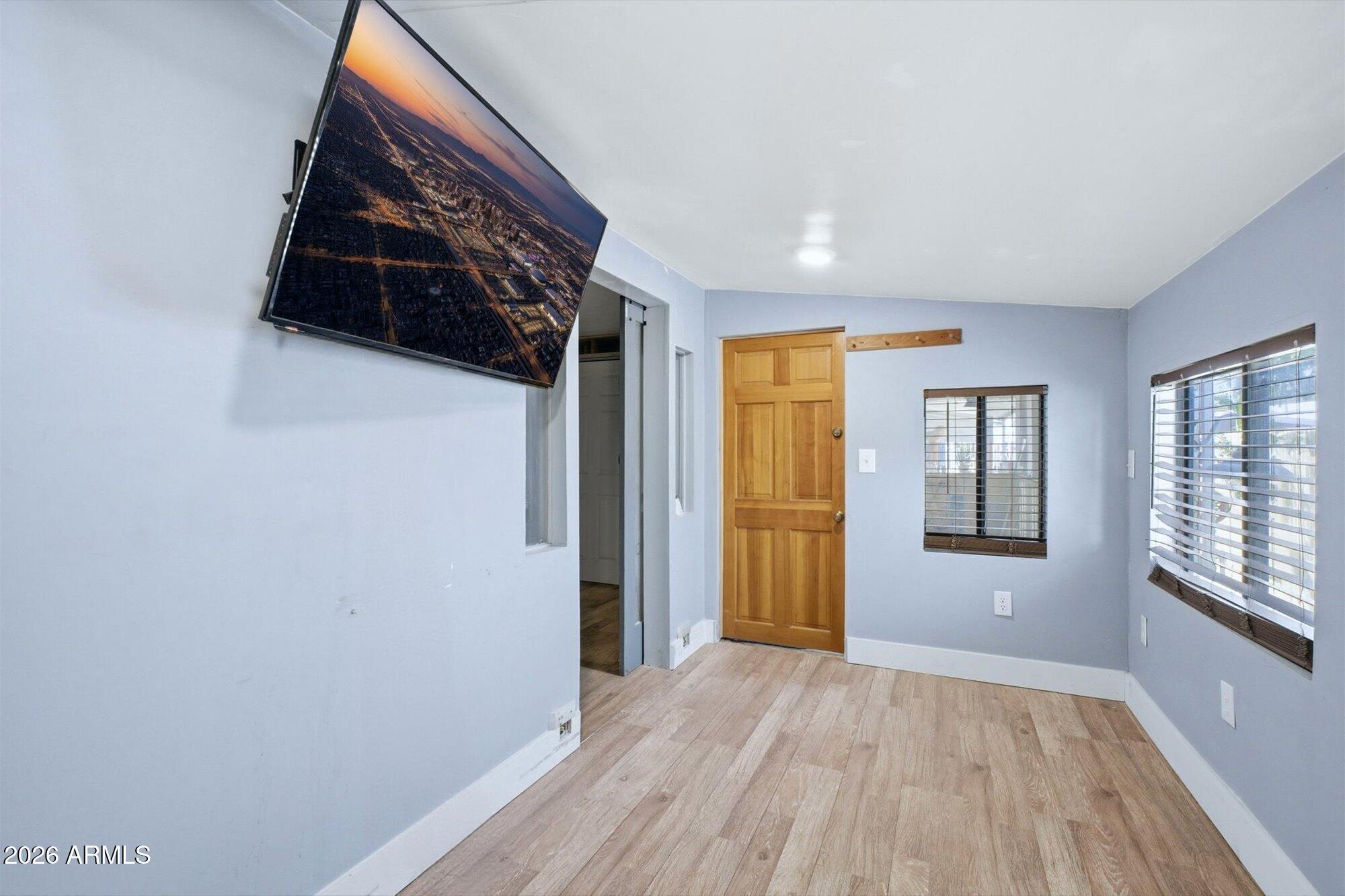 205 South Higley Road, Unit 183 Mesa, AZ 85206 - Photo 15 of 30 wooden floor in an empty room with a window