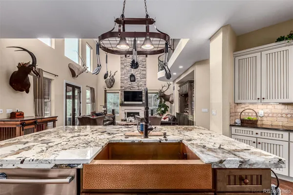 a kitchen with a stove and a chandelier