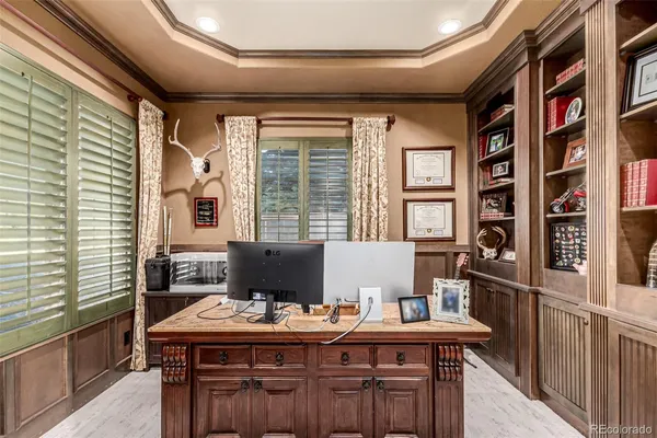 a view of a workspace with furniture and a window