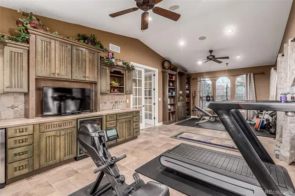 a view of a livingroom with furniture hardwood floor and a ceiling fan
