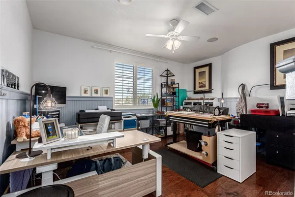 a view of a workspace with furniture and a window