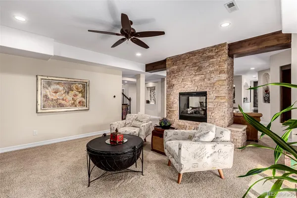 a living room with furniture and a fireplace