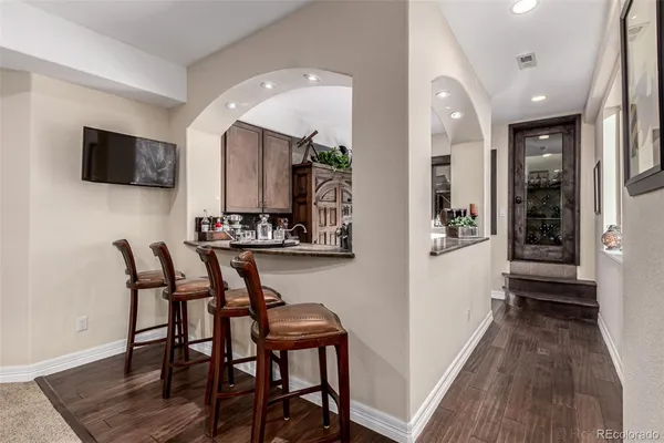 a view of a dining room with furniture and wooden floor