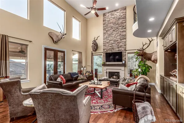 a living room with fireplace furniture and a large window