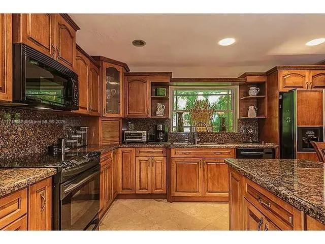 a bedroom with furniture and a large window