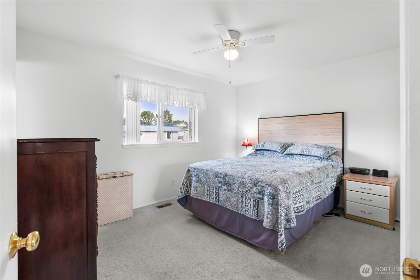 1205 195th Street Long Beach, WA 98631 - Photo 14 of 36 a bedroom with a bed and a chandelier