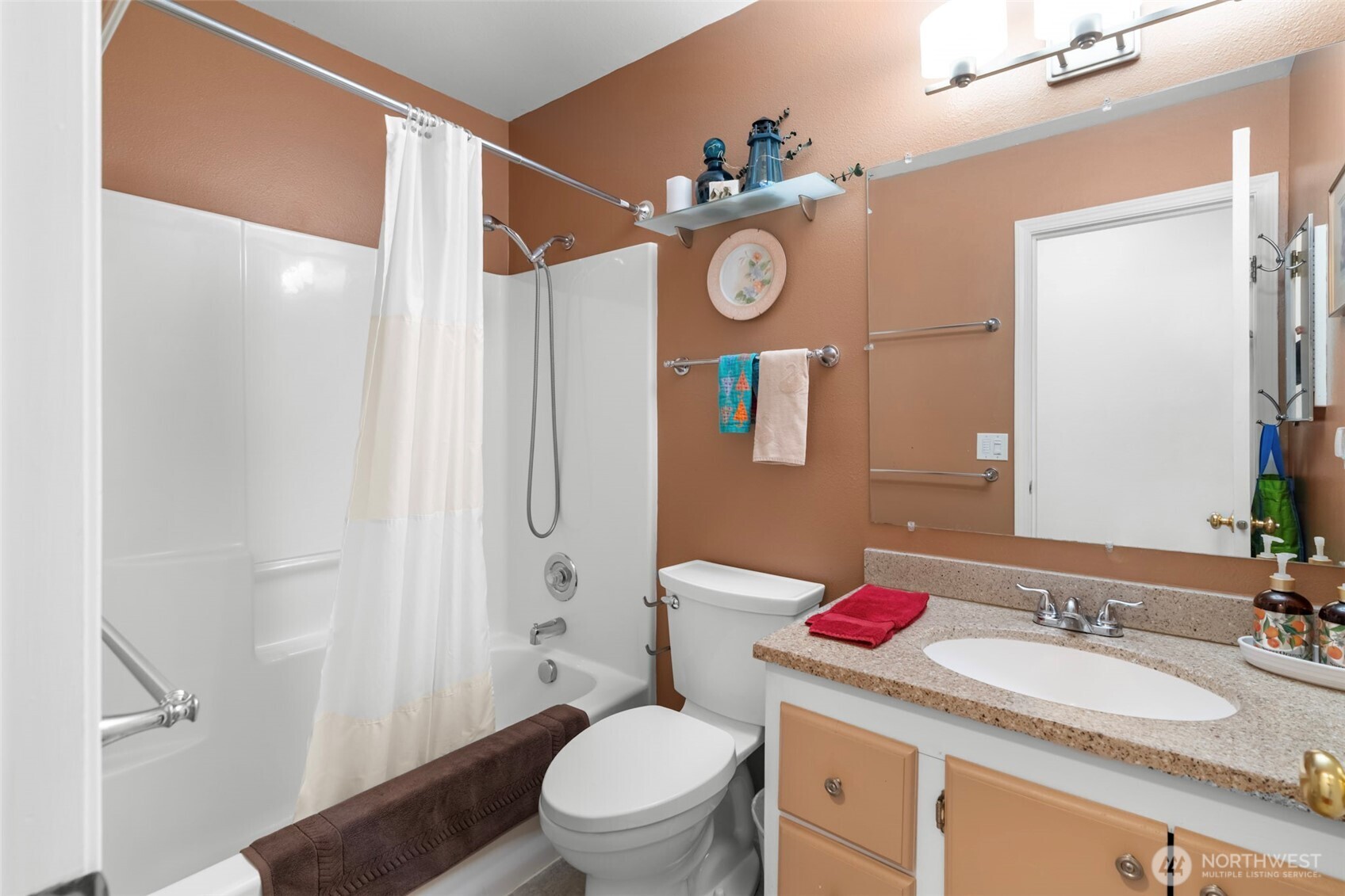 1205 195th Street Long Beach, WA 98631 - Photo 19 of 36 a bathroom with a toilet a sink and a mirror