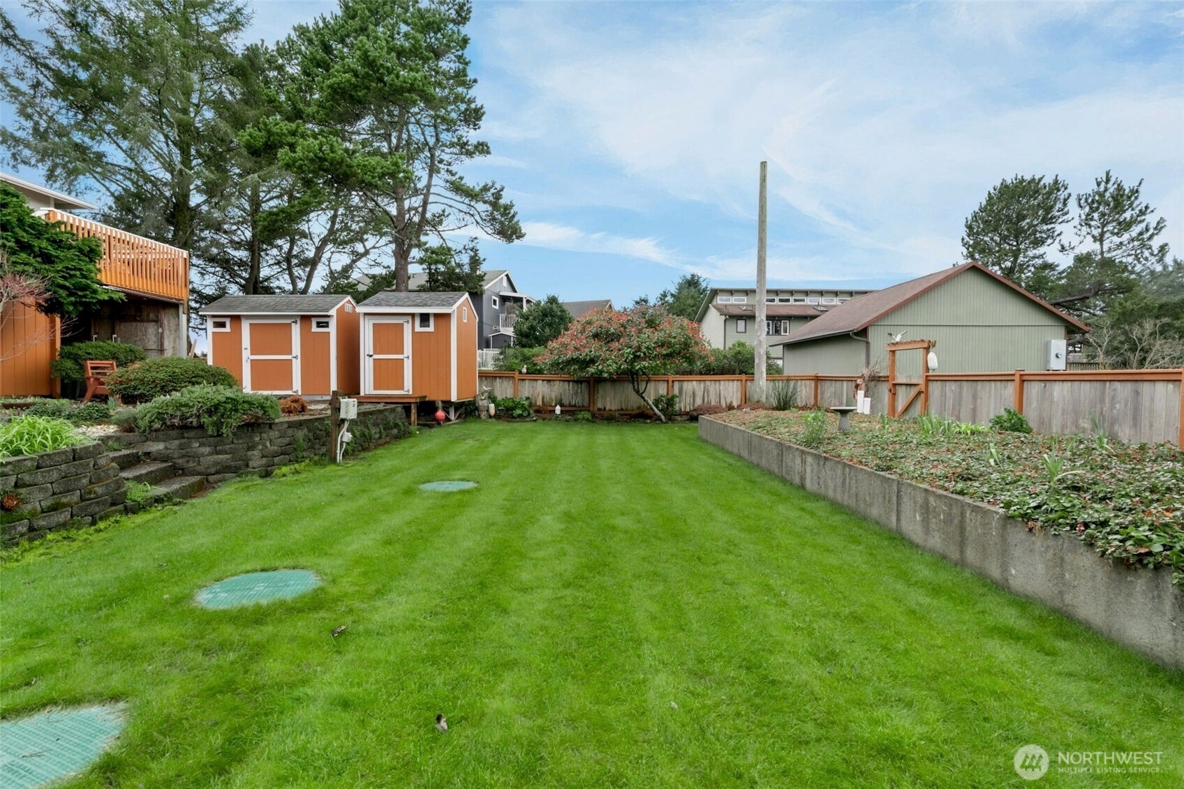 1205 195th Street Long Beach, WA 98631 - Photo 34 of 36 a front view of a house with a yard and potted plants