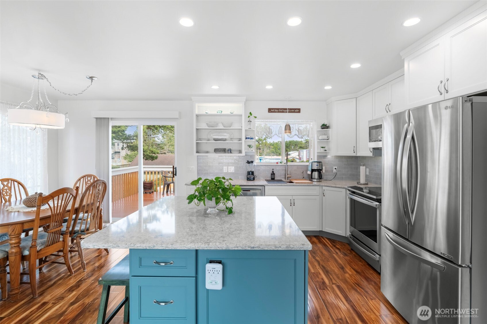 1205 195th Street Long Beach, WA 98631 - Photo 8 of 36 a kitchen with granite countertop a counter space cabinets stainless steel appliances and windows