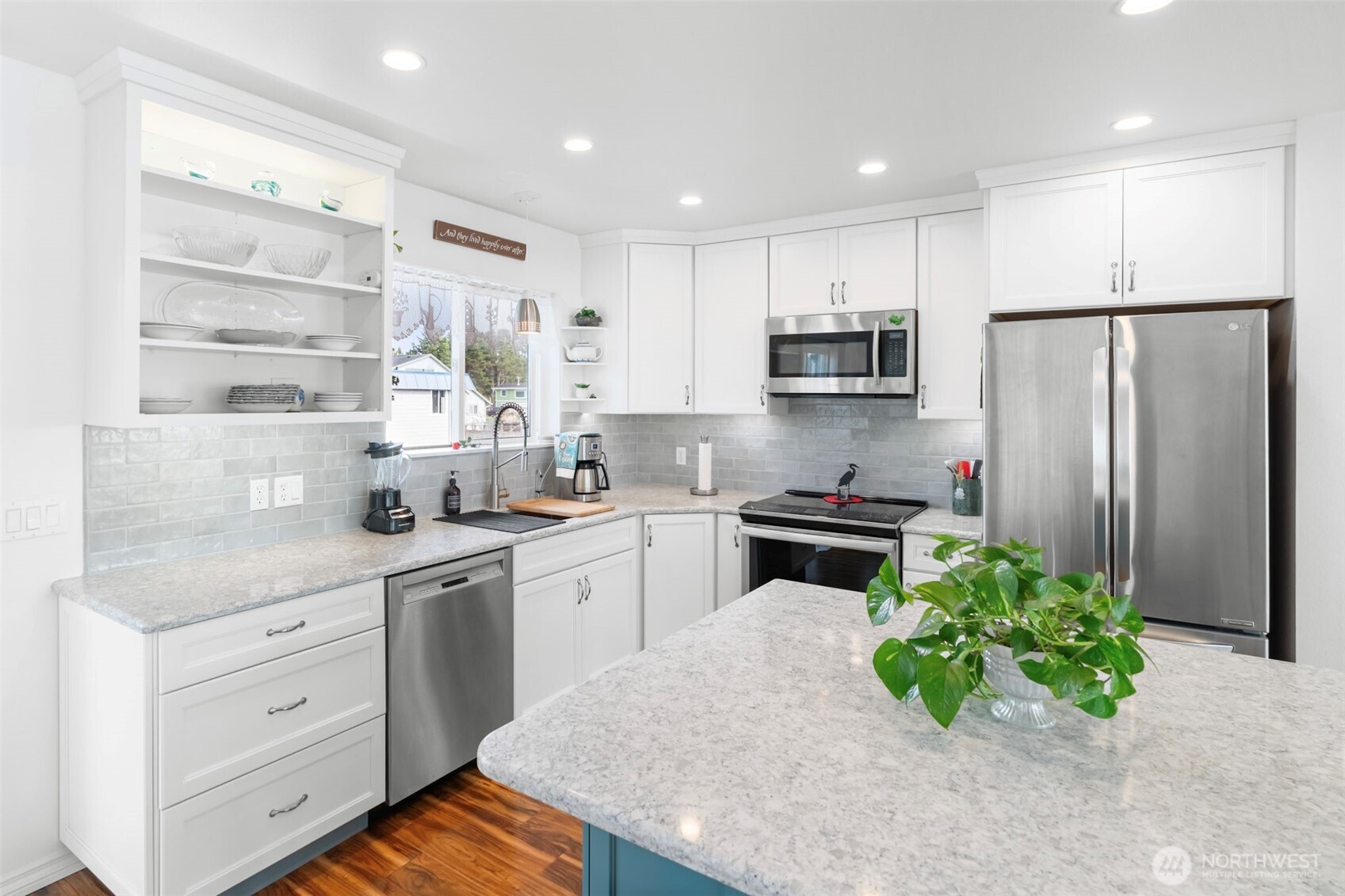 1205 195th Street Long Beach, WA 98631 - Photo 9 of 36 a kitchen with stainless steel appliances granite countertop a refrigerator sink and stove