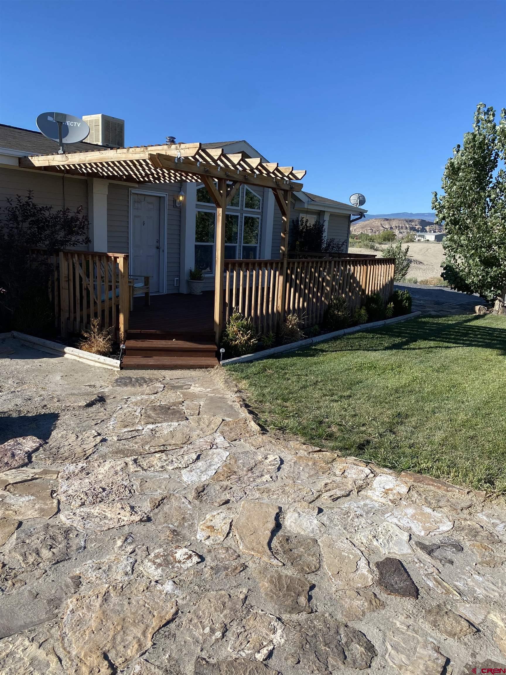7156 Peach Valley Road Delta, CO 81416 - Photo 1 of 33 a front view of a house with a garden