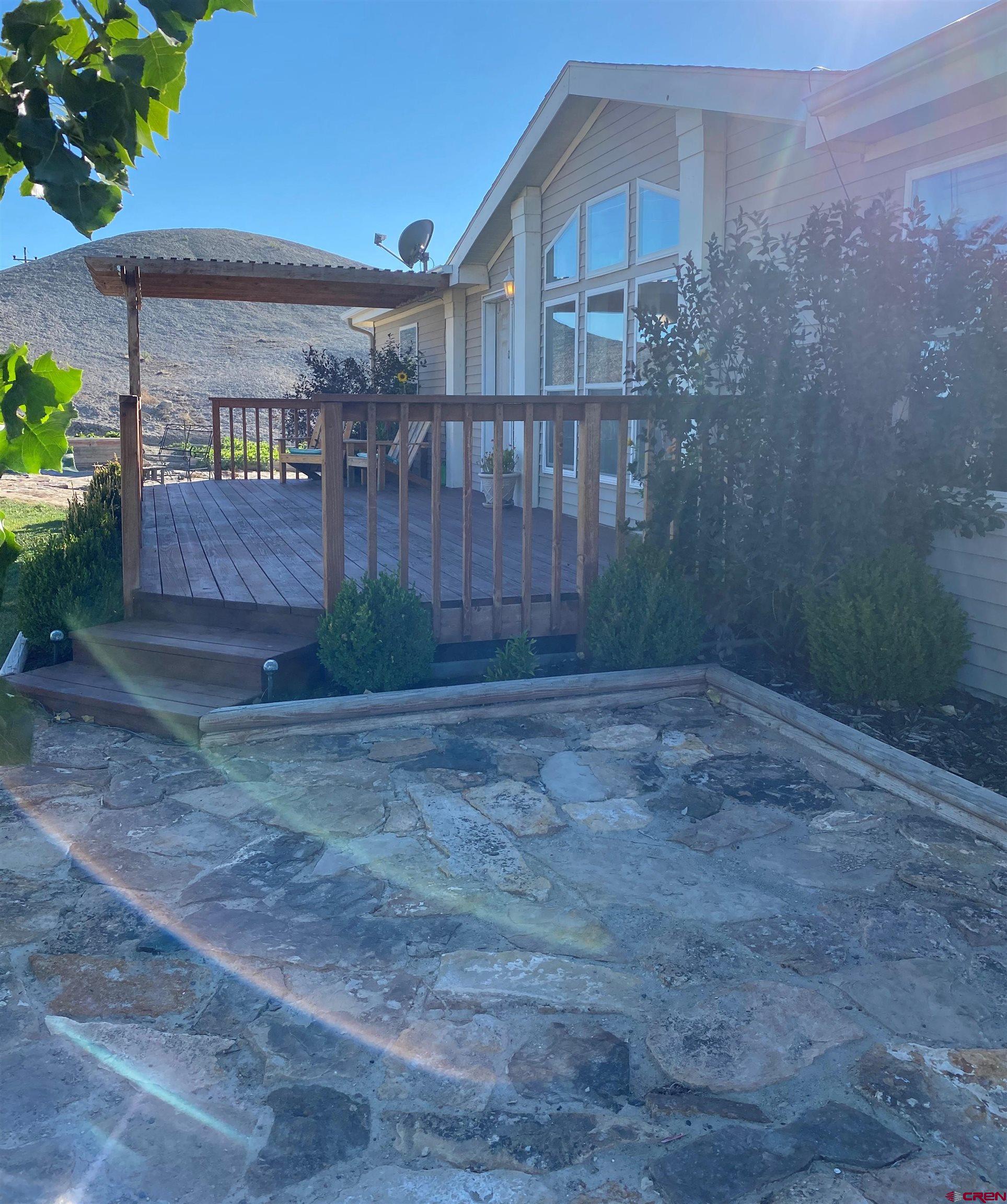 7156 Peach Valley Road Delta, CO 81416 - Photo 2 of 33 a front view of a house with garden