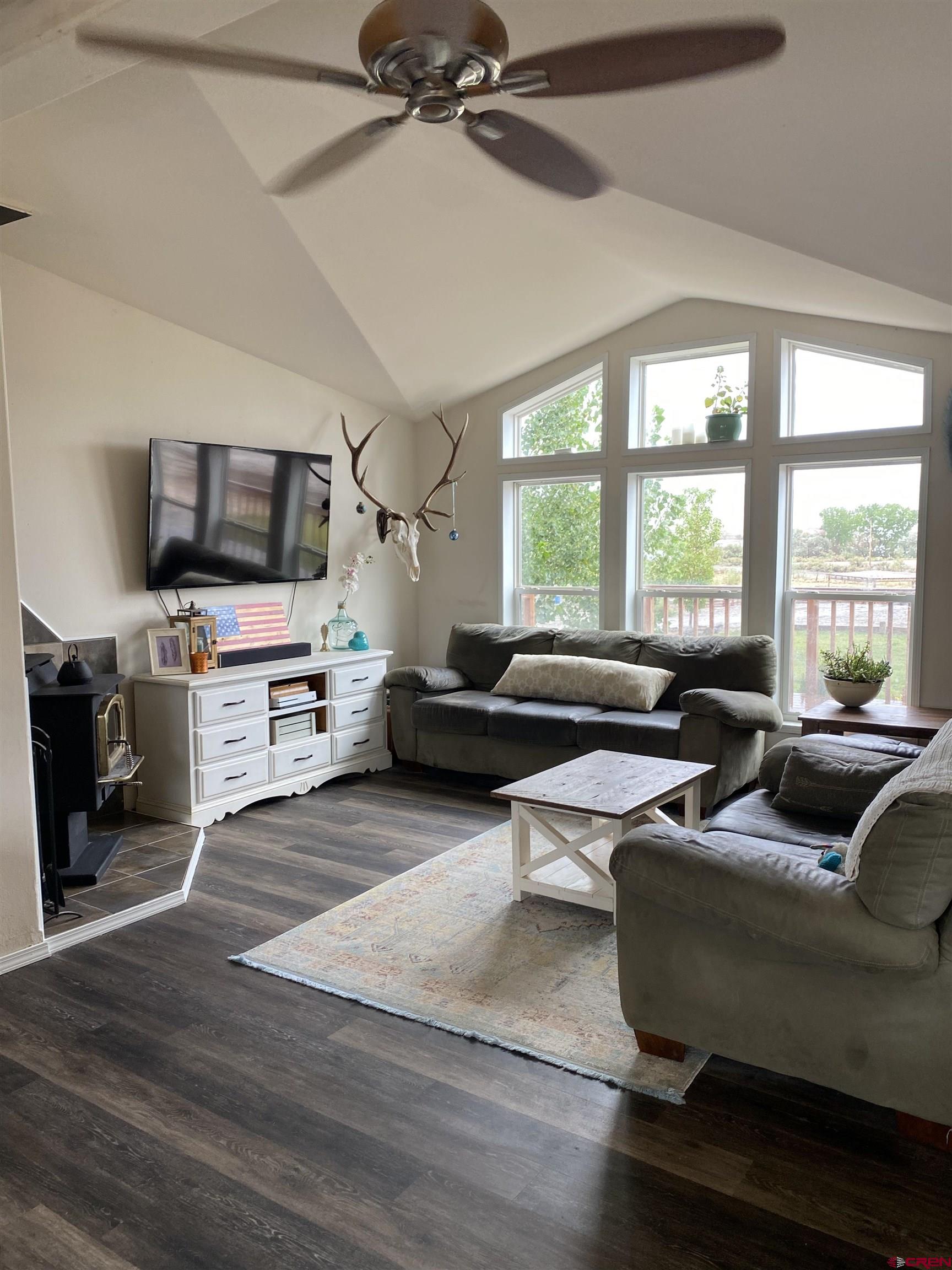 7156 Peach Valley Road Delta, CO 81416 - Photo 16 of 33 a living room with furniture and a flat screen tv