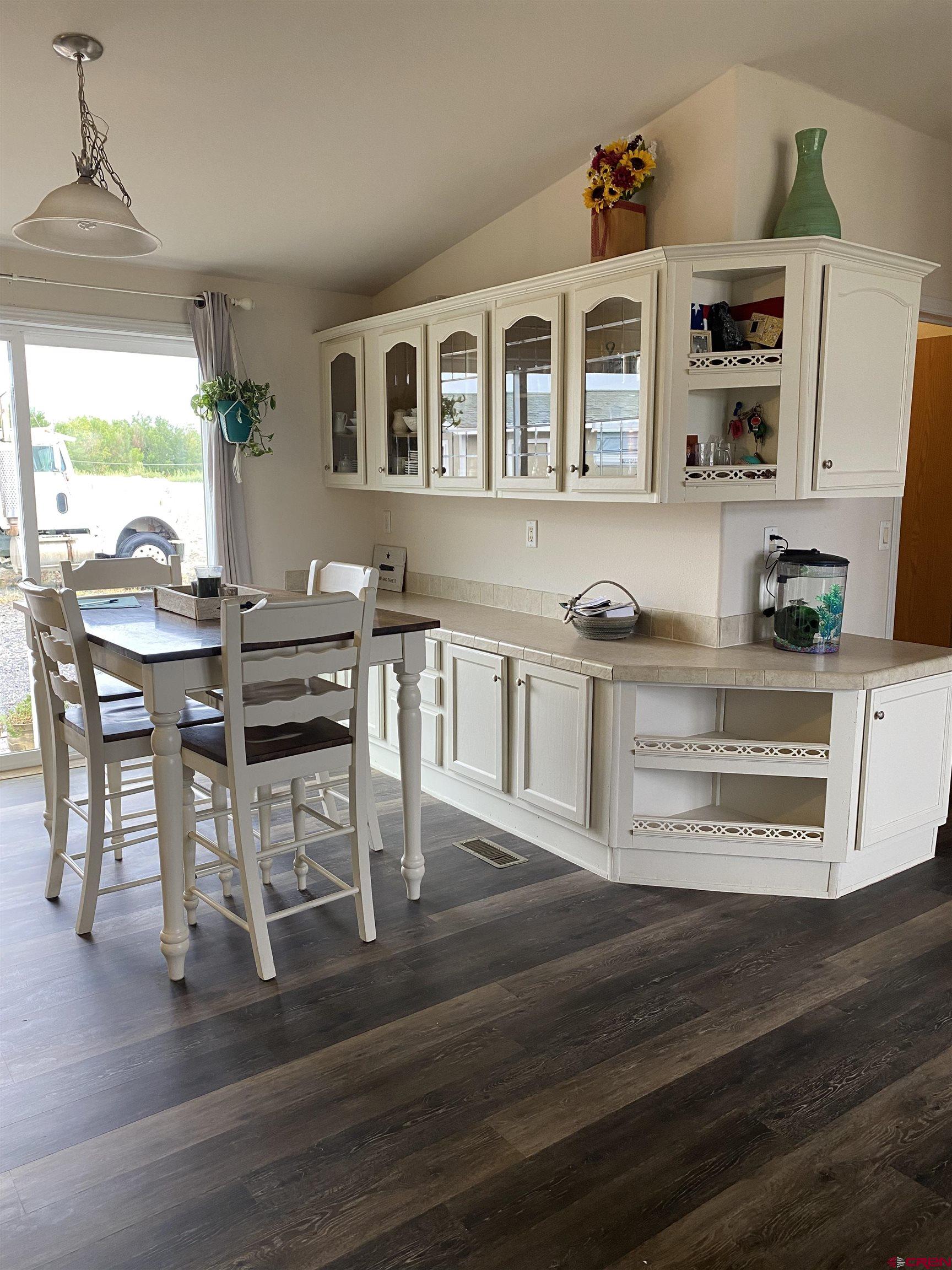 7156 Peach Valley Road Delta, CO 81416 - Photo 18 of 33 a view of a dining room with furniture window and wooden floor