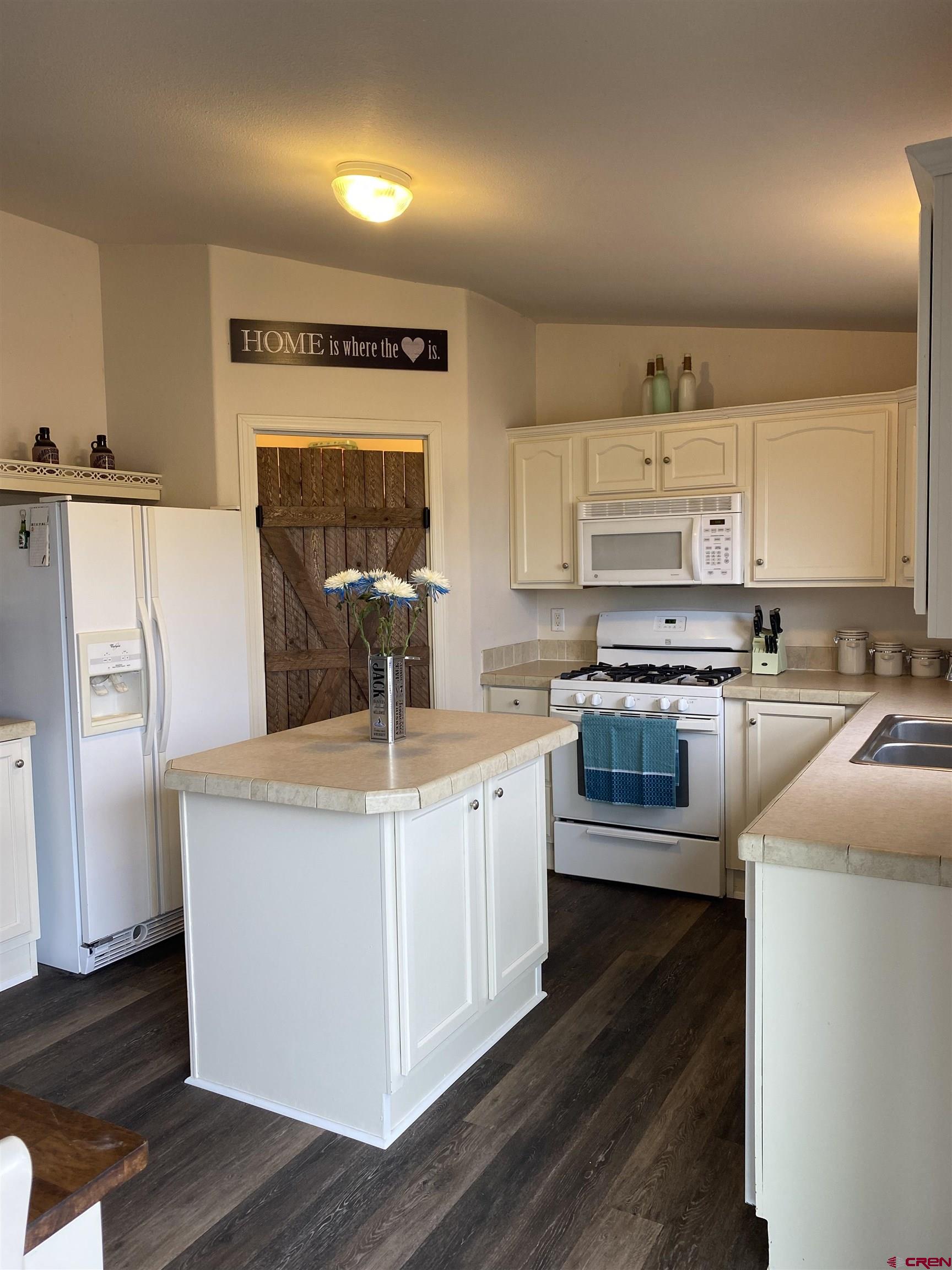 7156 Peach Valley Road Delta, CO 81416 - Photo 19 of 33 a kitchen with stainless steel appliances a stove a sink and a refrigerator