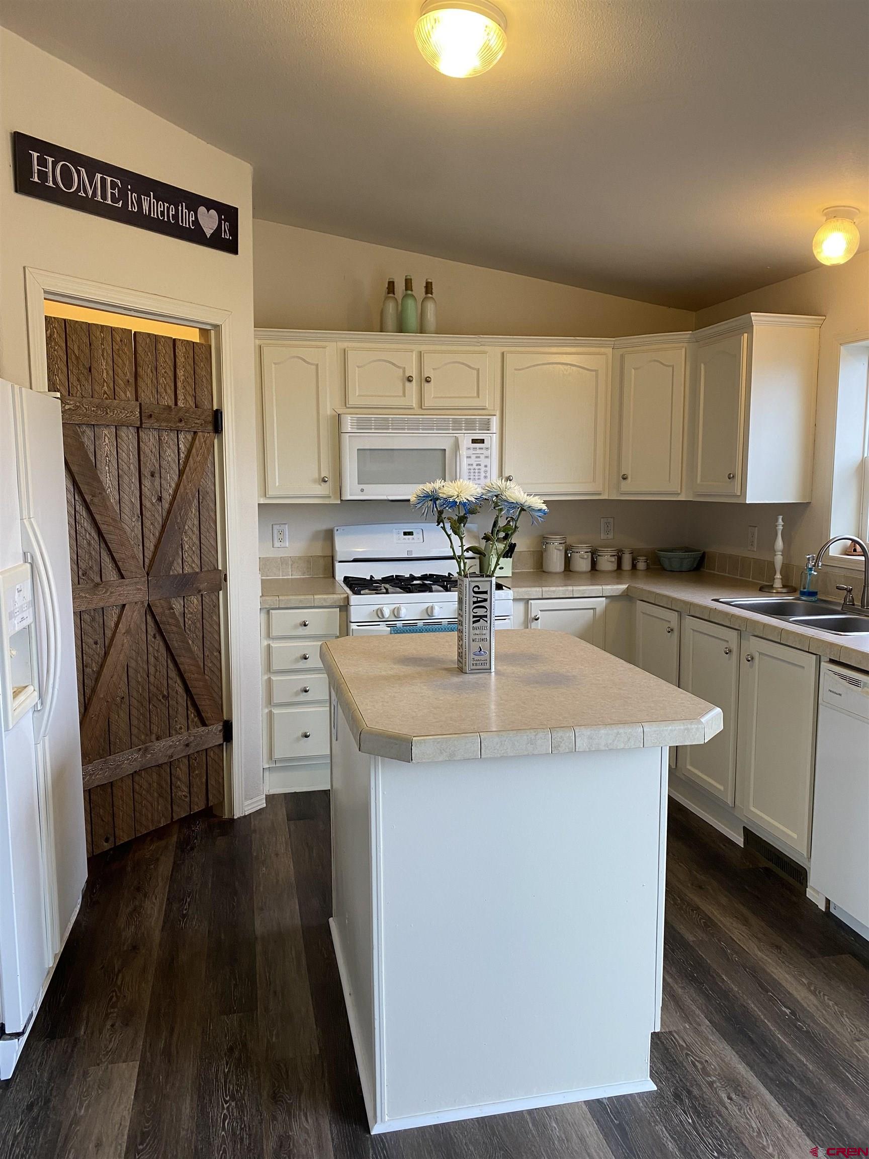 7156 Peach Valley Road Delta, CO 81416 - Photo 20 of 33 a kitchen with stainless steel appliances granite countertop a sink stove and refrigerator
