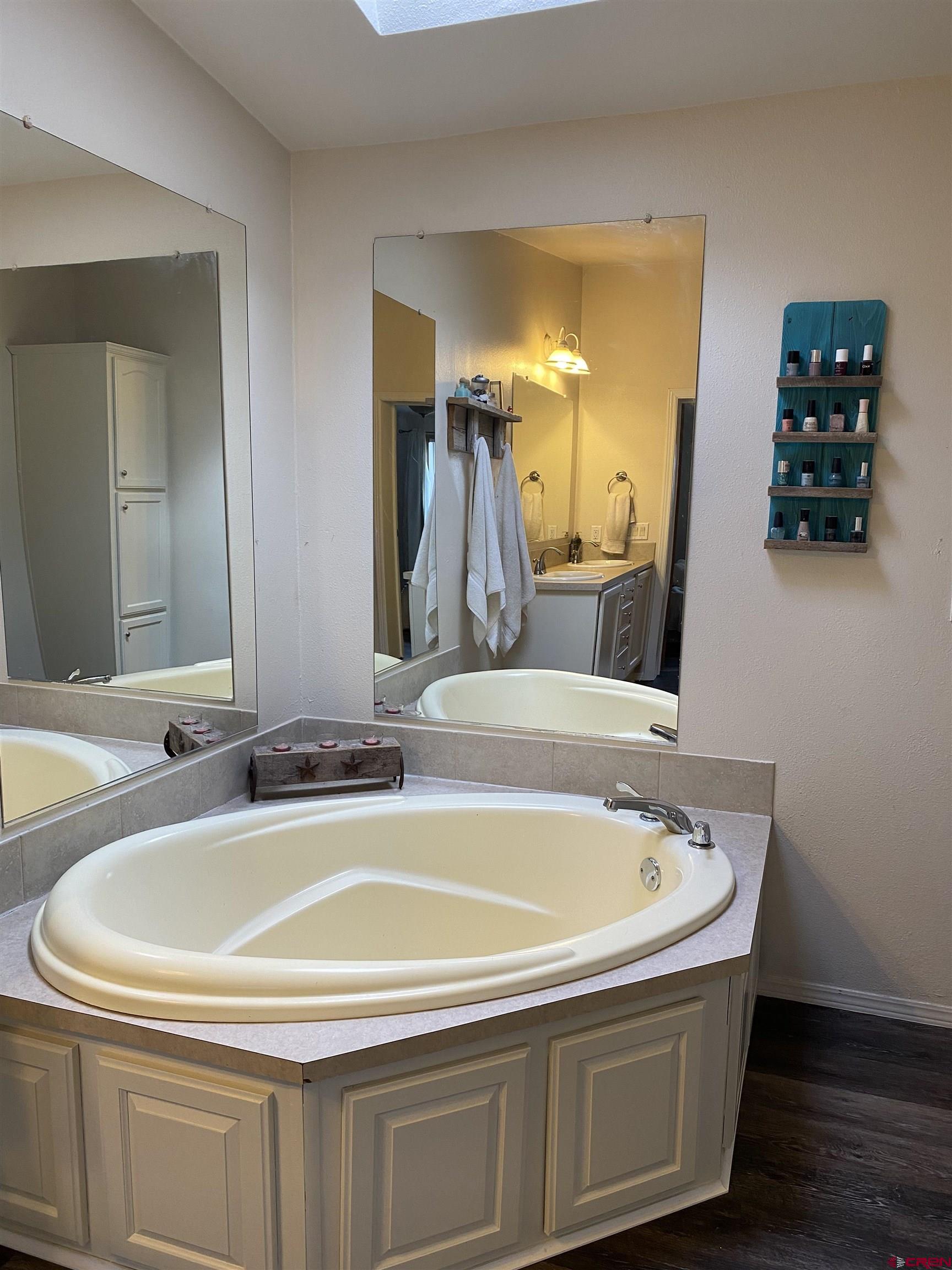 7156 Peach Valley Road Delta, CO 81416 - Photo 24 of 33 a bathroom with a tub a sink and a mirror