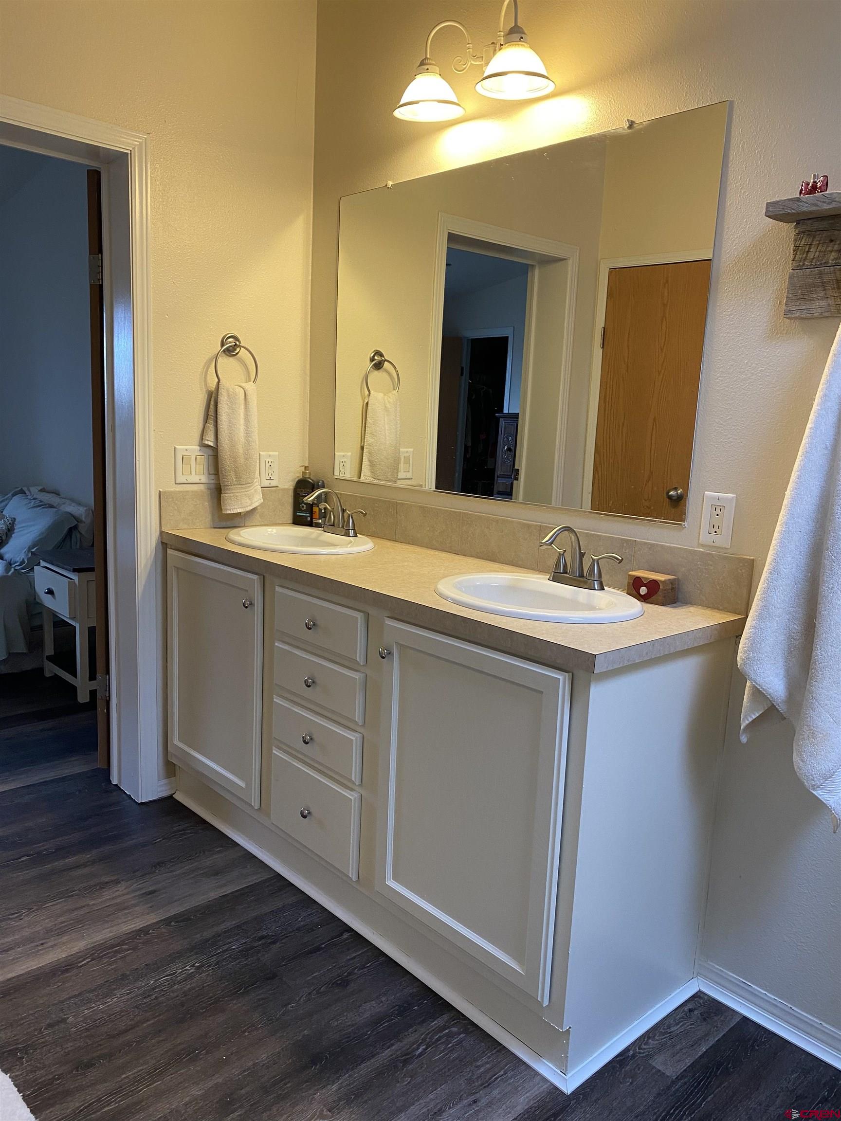7156 Peach Valley Road Delta, CO 81416 - Photo 25 of 33 a bathroom with a double vanity sink and a mirror