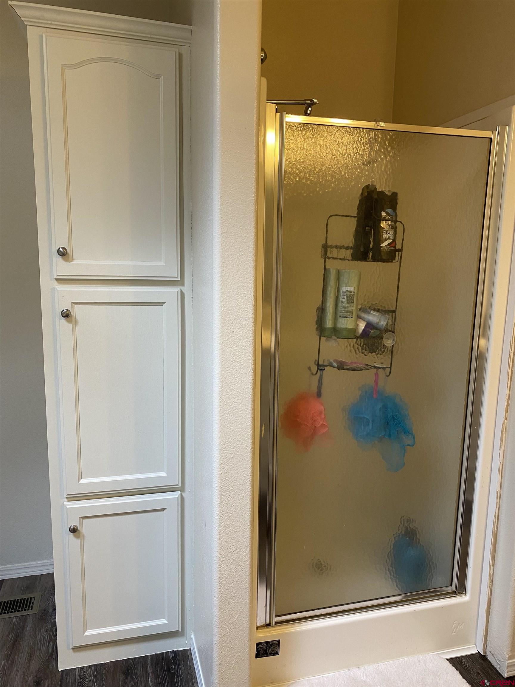 7156 Peach Valley Road Delta, CO 81416 - Photo 26 of 33 a bathroom with a glass shower door