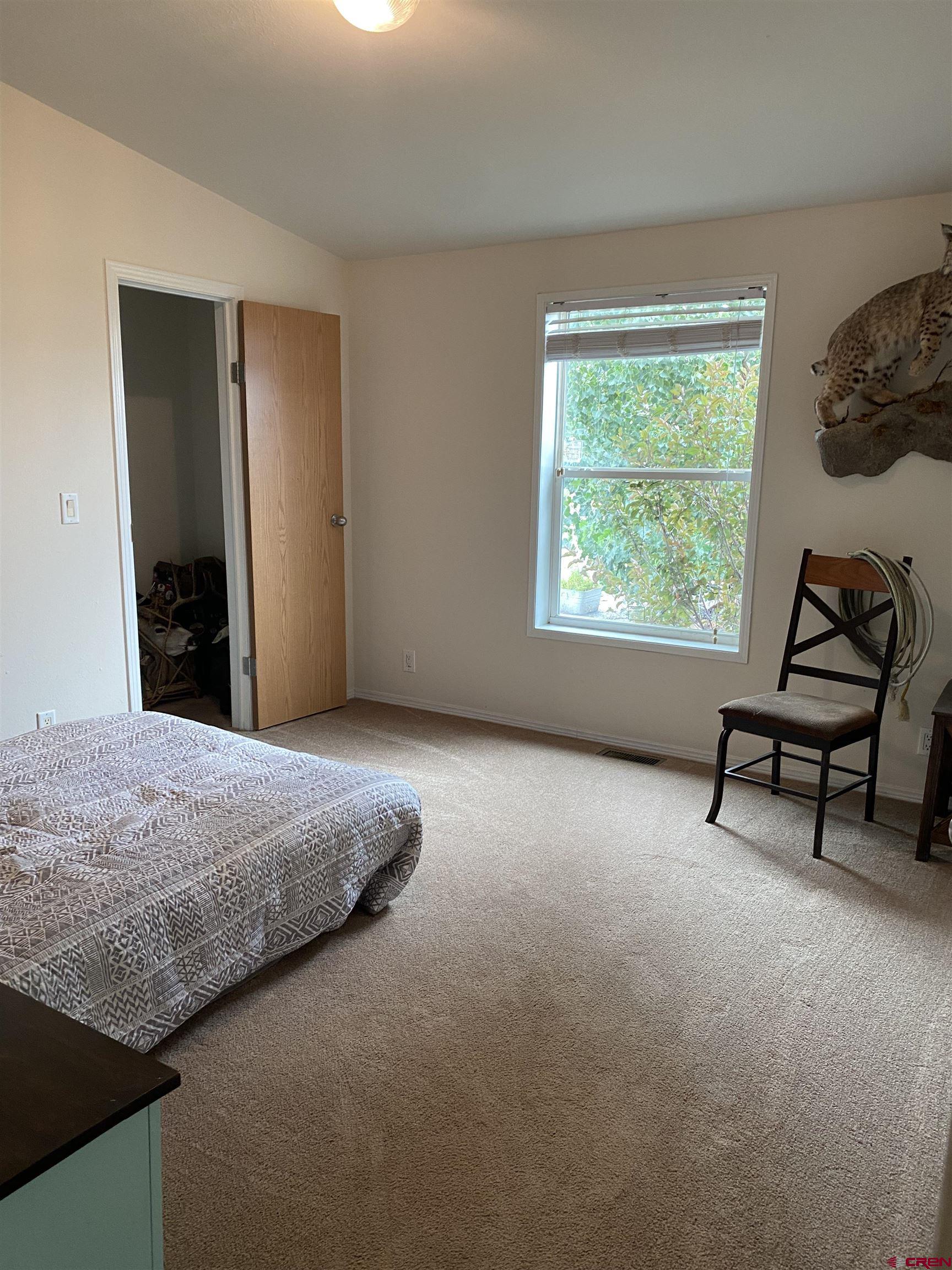 7156 Peach Valley Road Delta, CO 81416 - Photo 27 of 33 a bedroom with a bed and a window