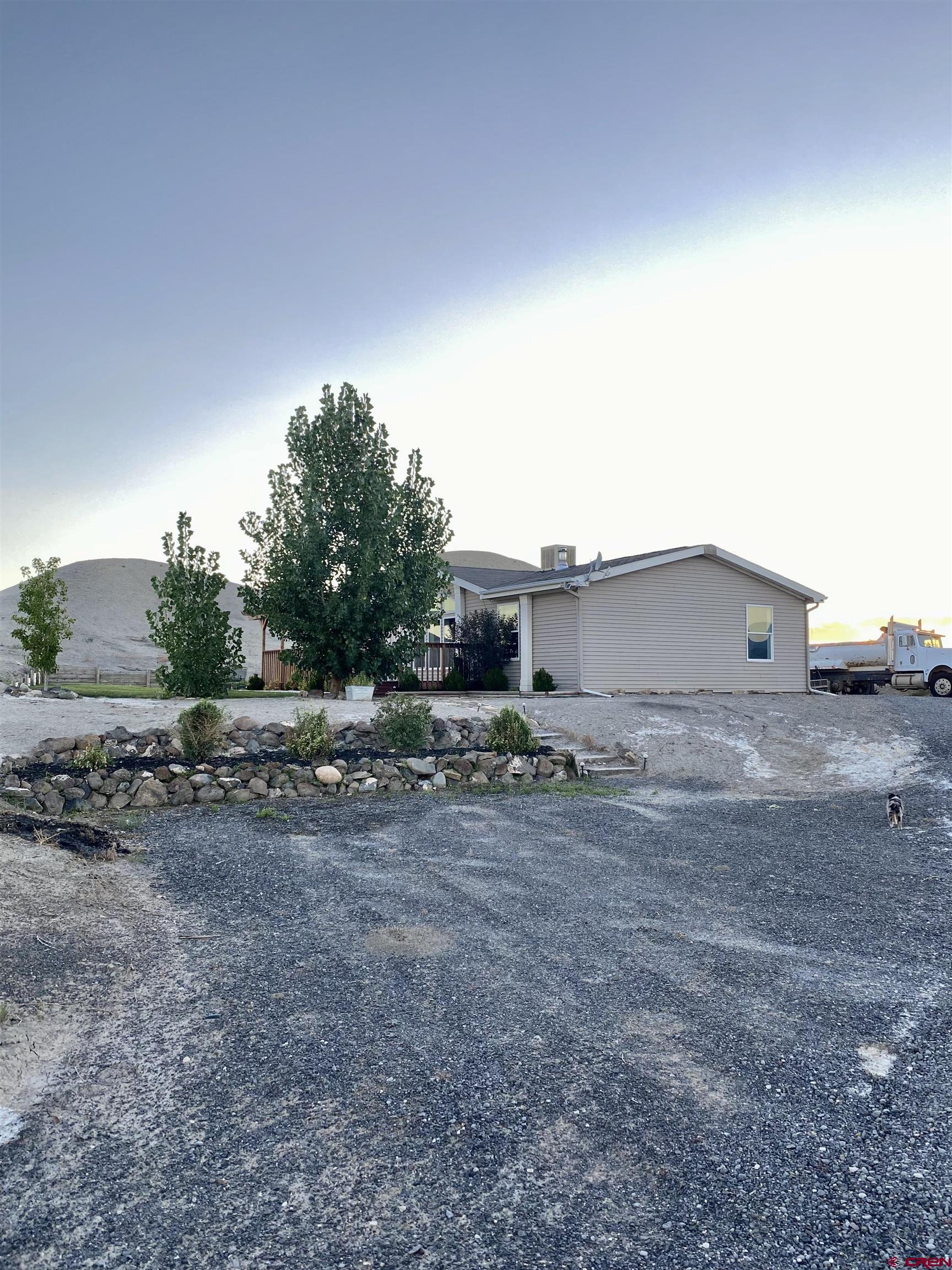 7156 Peach Valley Road Delta, CO 81416 - Photo 33 of 33 a view of a house with a backyard