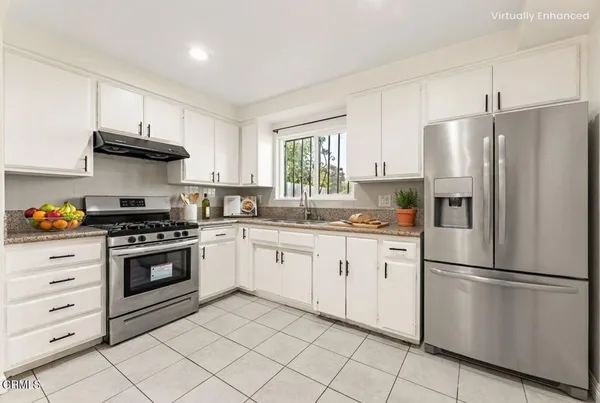 a kitchen with stainless steel appliances granite countertop a stove a refrigerator and a refrigerator