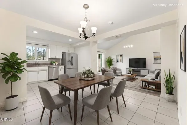 a view of a dining room with furniture and a potted plant